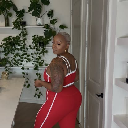 Kai Michelle in a red and white activewear set